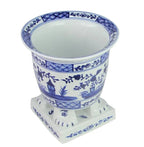 Jardinière sur pied bleu foncé et blanche avec motif de scène de village